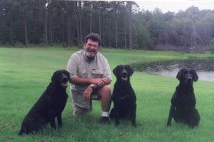 Woody with three titled black Labs
