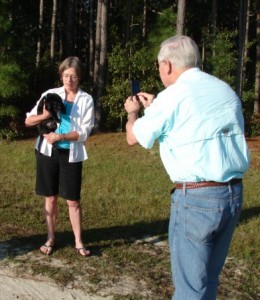 Man and woman with Labrador retriever puppy
