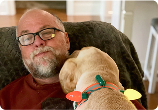 Dog sleeping on old man